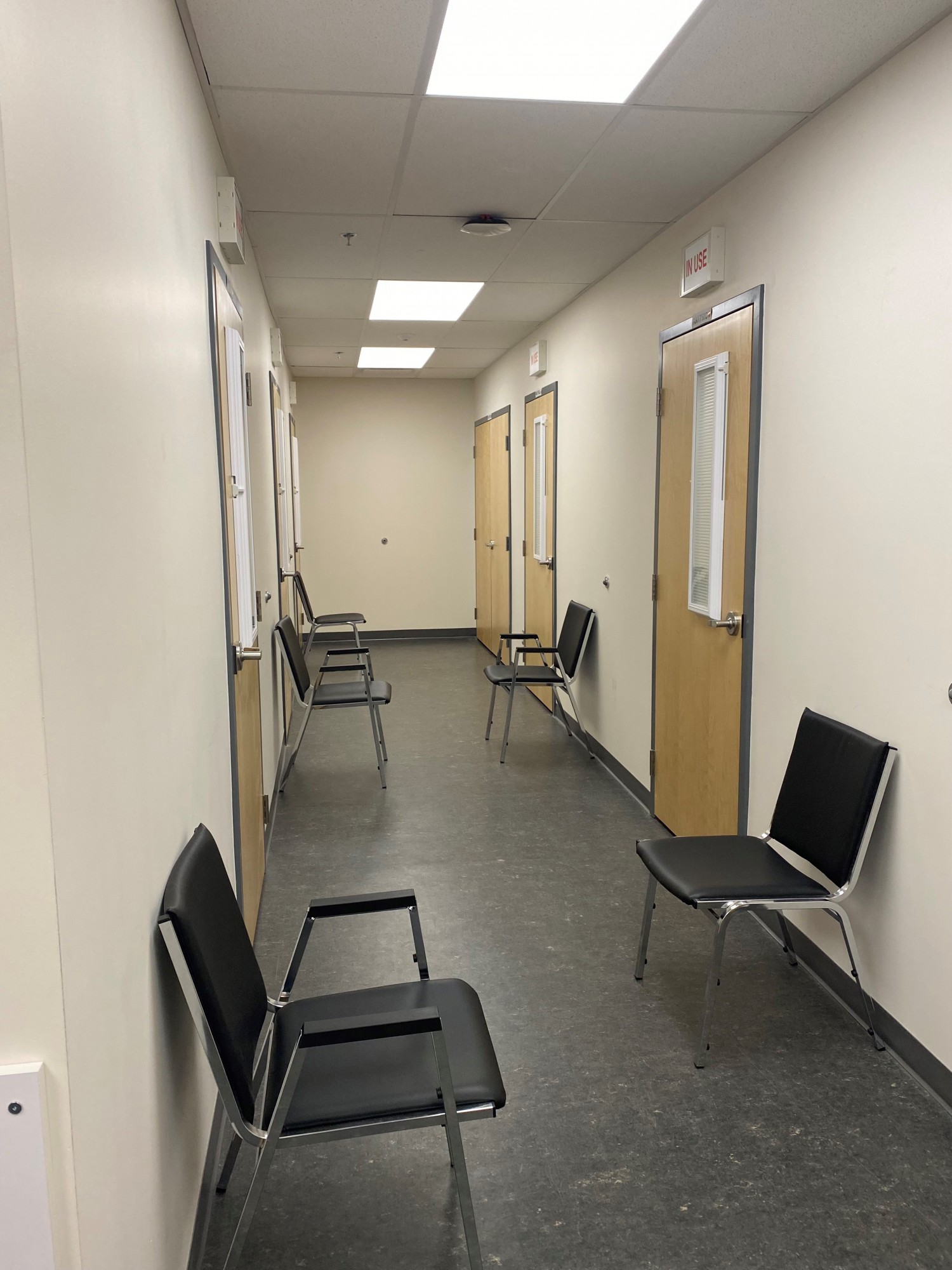 Interview rooms line either side of a hallway.