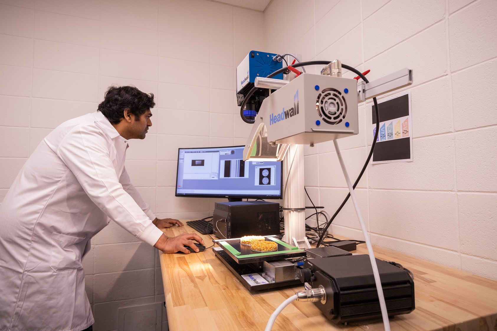 a researcher uses equipment in a lab space.