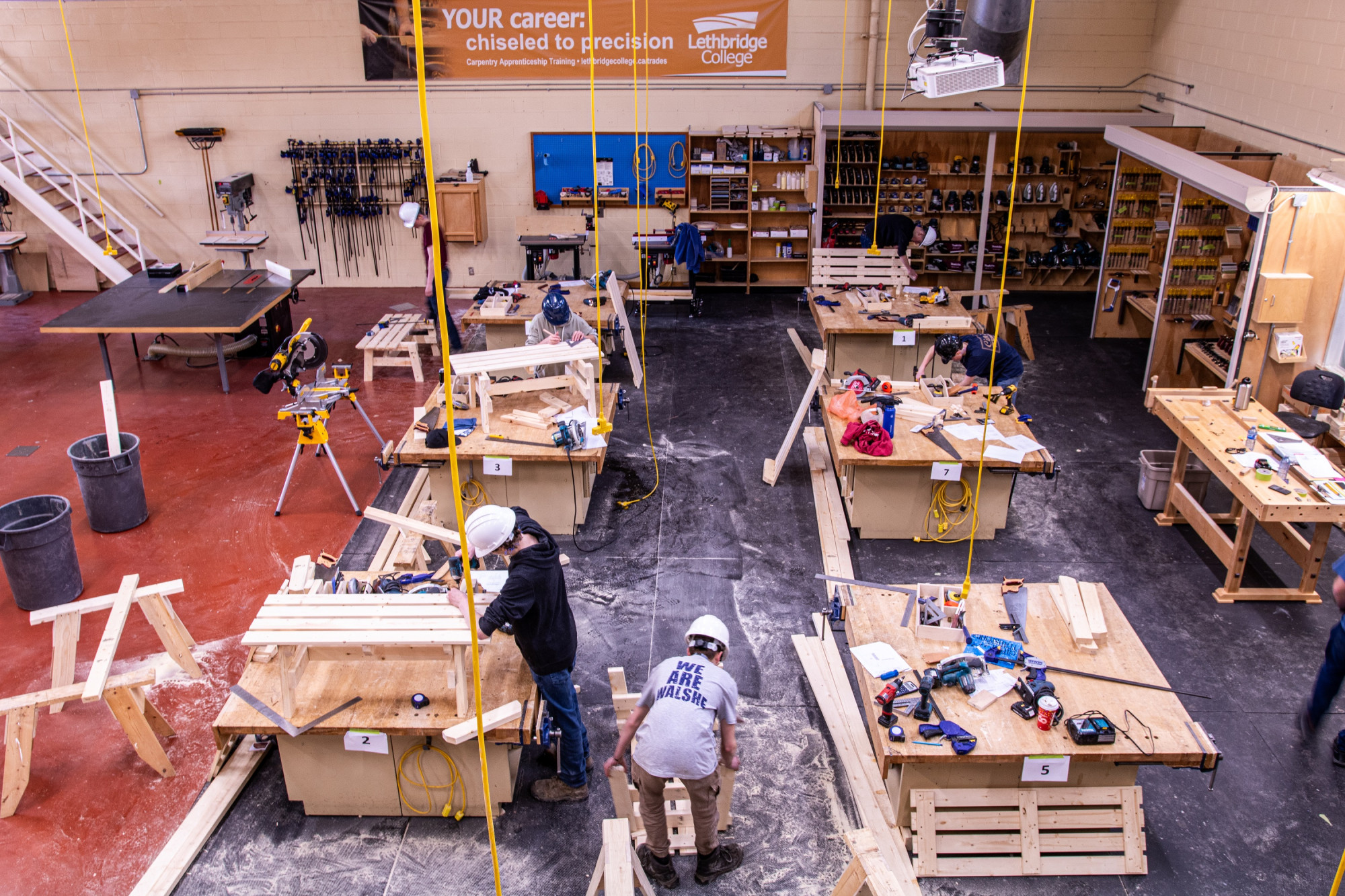 An overhead view of students woodworking in a lab.