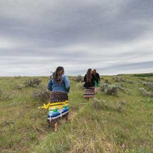 Indigenous women walking in a field