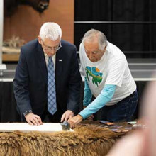 Dr. Leroy Little Bear (right) indicates to Lethbridge College President and CEO Dr. Brad Donaldson where to sign his name on the Buffalo Treaty in March at Lethbridge College.