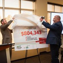 Lethbridge College's Dennis Sheppard (left) and CHBA-Lethbridge Region president Mike Schmidtler unveil the final total from the College Home project