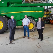 Three people pose in front of agricultural equipment. From left to right: Jason Sentes, Chief Executive Officer, 1st Choice Savings and Credit Union; Byrne Cook, Chair, School of Agriculture, Lethbridge College; Cassidy Langridge, Digital Branding Specialist, 1st Choice Savings and Credit Union