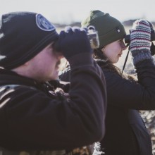 Bachelor of Ecosystem Management students look through binoculars during a bird-banding field trip.