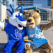 Two mascots pose for the camera