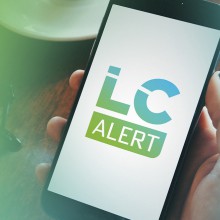 The LC Alert logo on a mobile phone.