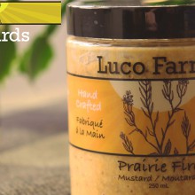 A jar of Luco Farms mustard on a table