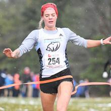 Kodiaks runner Sophia Nowicki crosses the finish line to win the 2018 CCAA national cross country championship.