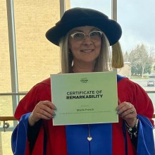 Lethbridge College instructor Dr. Sheila French, who earned her PhD in Experimental Psychology from the University of New Brunswick Saint John, poses with her certificate from Lethbridge College's You Are Remarkable event.