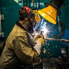 A Lethbridge College welding student works in the college's Welding Lab.